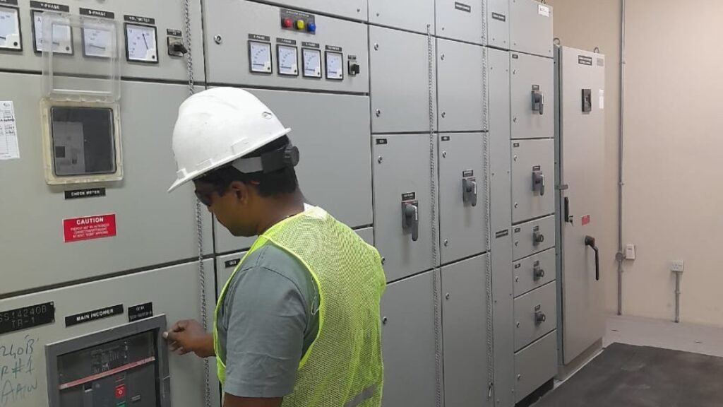 24/7 electrician inspecting electrical control panel for emergency electrical services in UAE